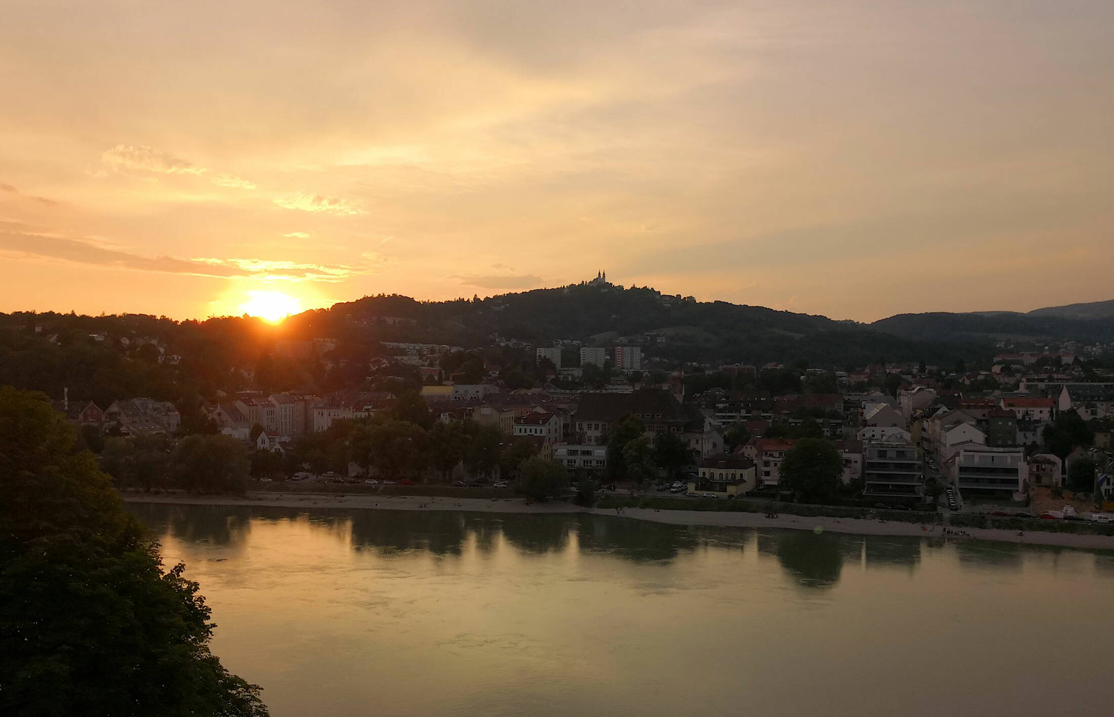 Die Sonne verschwindet im Donautal in Linz
